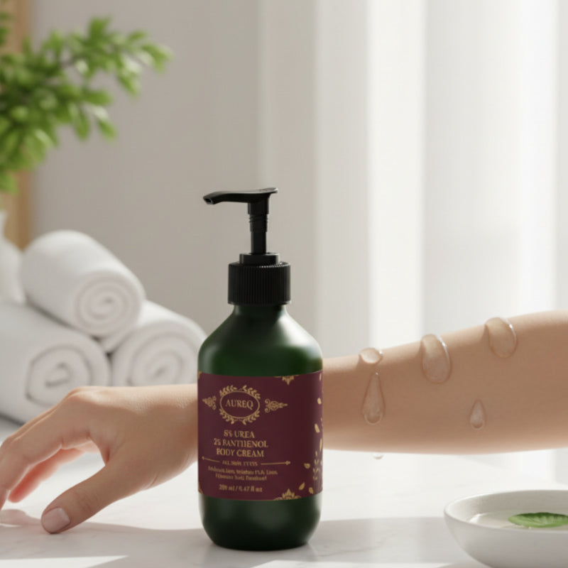 Green bottle with pump dispenser on a table with a hand and towel in the background