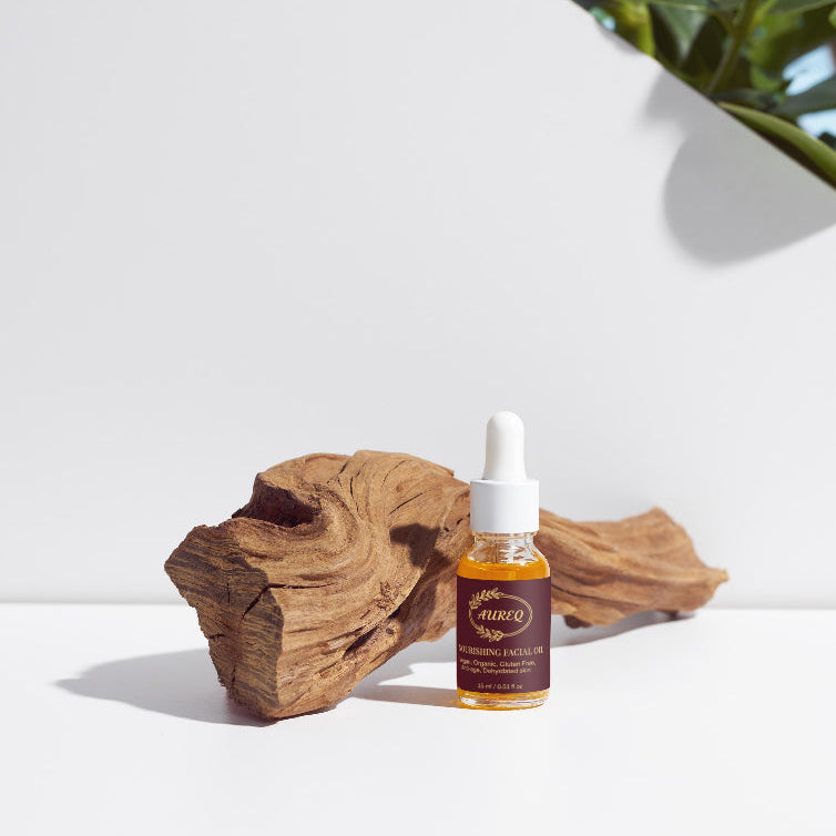 Bottle of Clevy product on a white surface with a wooden block and plant in the background