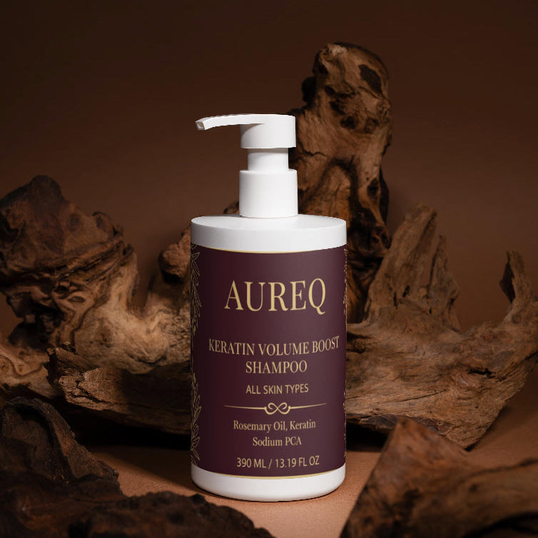 Aureq Keratin Volume Boost Shampoo bottle with a pump on a brown background