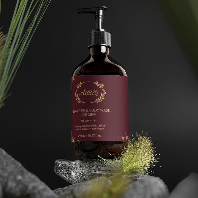 Bottle of Awen cologne and body wash for men on a dark background with greenery.
