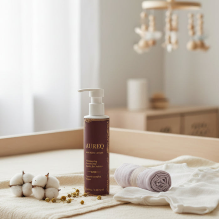  Aureo bottle on a bed with white bedding and decorative items.