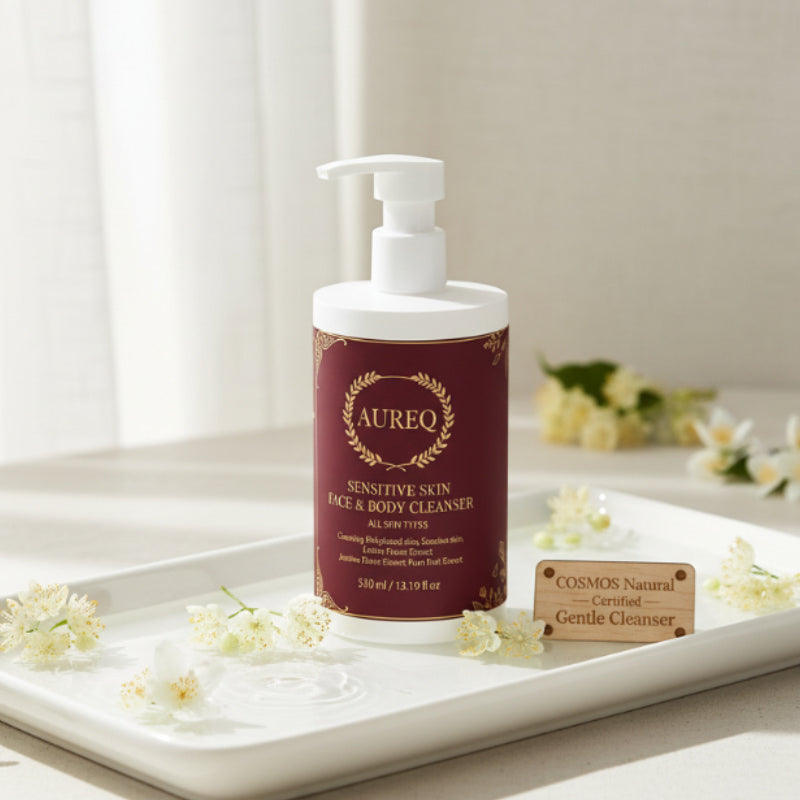 Aureq sensitive skin face and body cleanser bottle on a tray with flowers