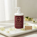 Aureq sensitive skin face and body cleanser bottle on a tray with flowers