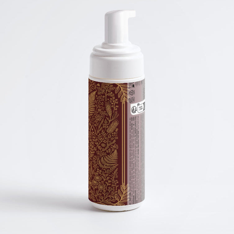 Foam soap dispenser with decorative brown pattern on a white background